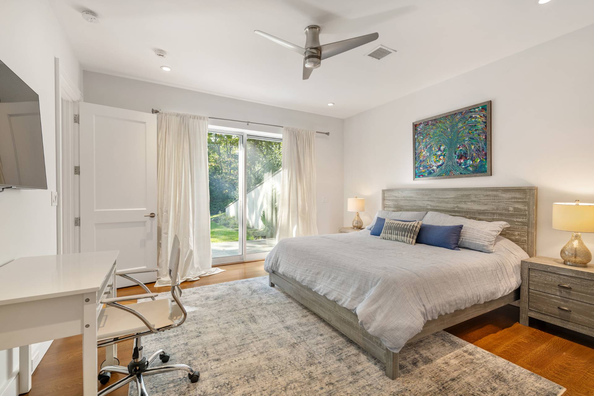 Undisclosed Address Sag Harbor, NY 11963 - Photo 27 of 36 a bedroom with a bed and large windows