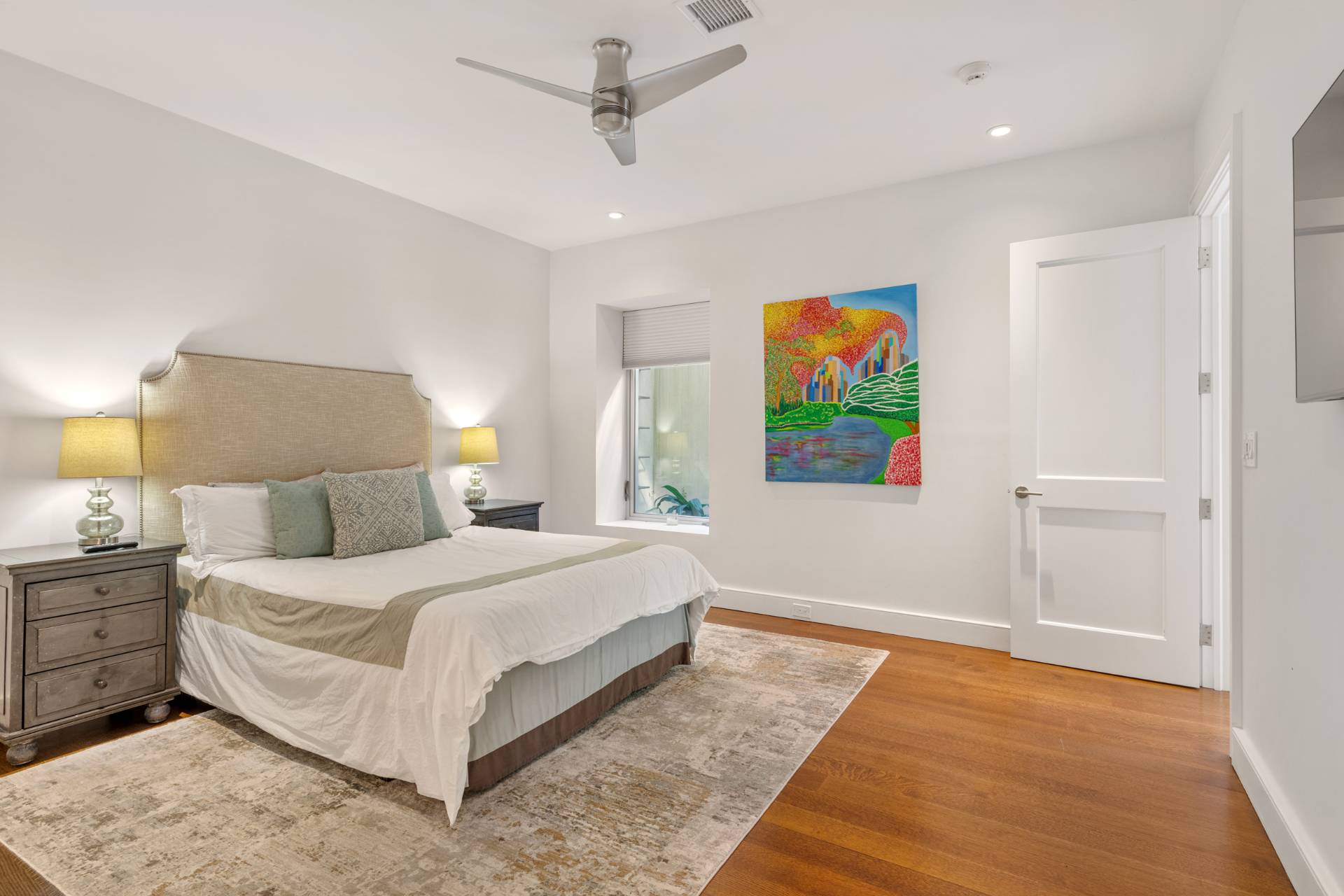 Undisclosed Address Sag Harbor, NY 11963 - Photo 29 of 36 a bedroom with a bed and a painting on the wall