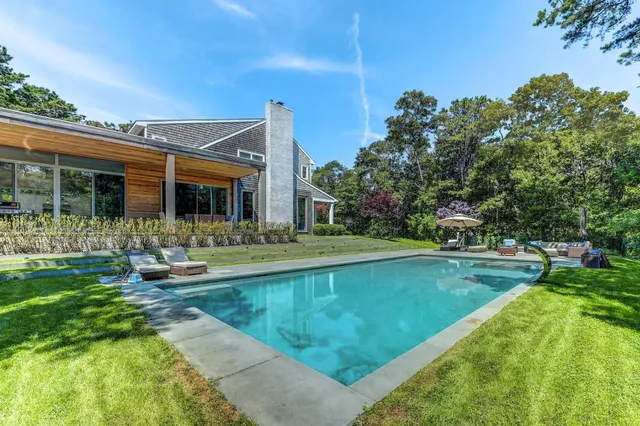 a view of a house with swimming pool and a yard
