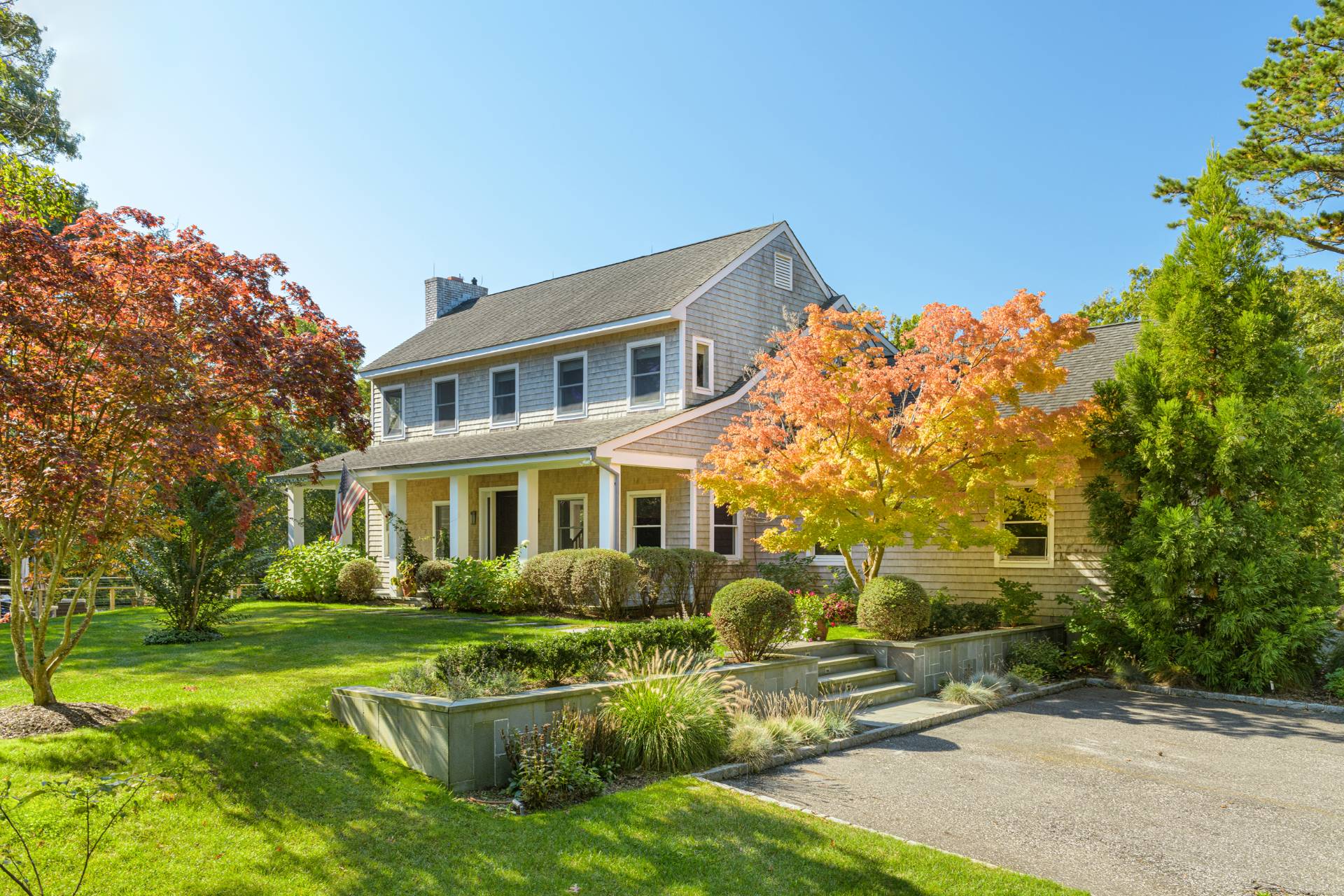 Undisclosed Address Sag Harbor, NY 11963 - Photo 35 of 36 a front view of a house with garden and trees