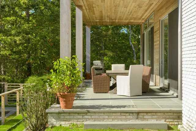 a view of swimming pool with large trees