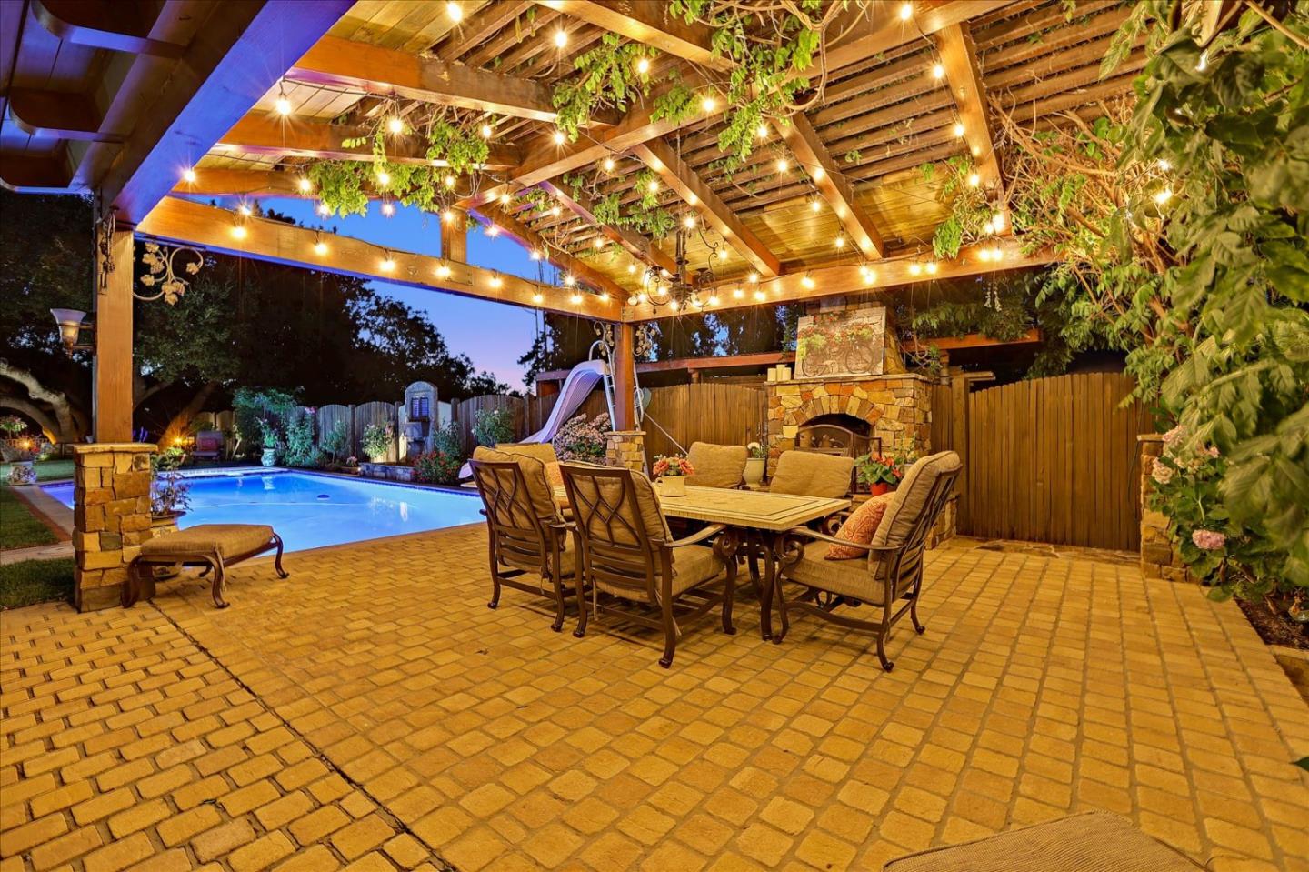 10091 Byrne Avenue Cupertino, CA 95014 - Photo 16 of 21 a view of a patio with table and chairs with wooden floor and fence