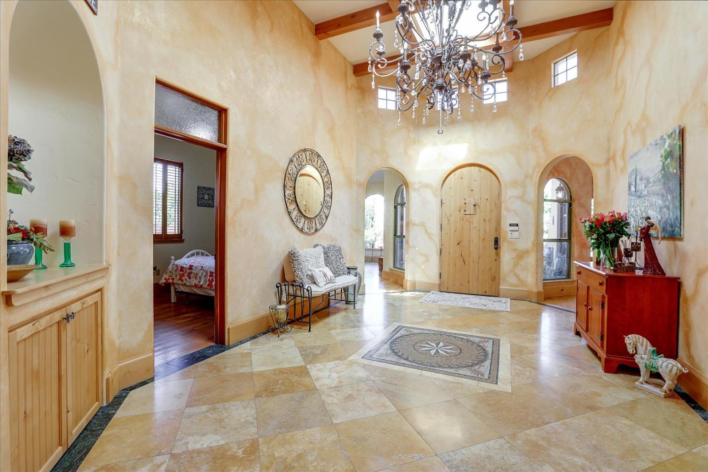 10091 Byrne Avenue Cupertino, CA 95014 - Photo 9 of 21 a living room with fireplace furniture and a chandelier