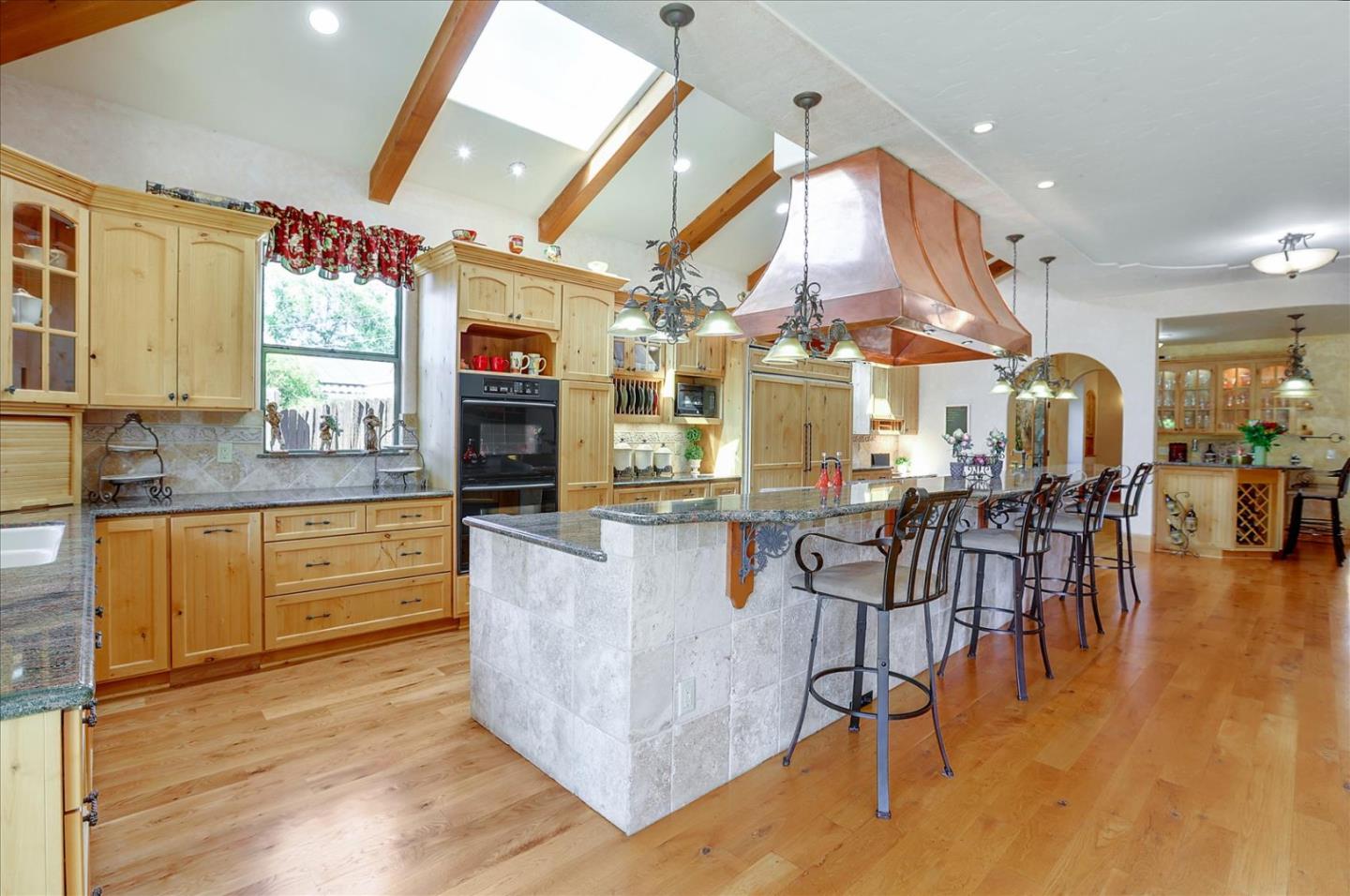 10091 Byrne Avenue Cupertino, CA 95014 - Photo 10 of 21 a kitchen with stainless steel appliances granite countertop wooden floors and large window