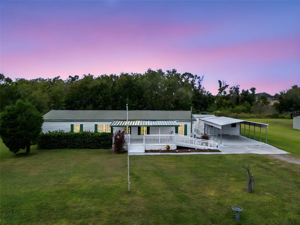 a view of a house with a big yard