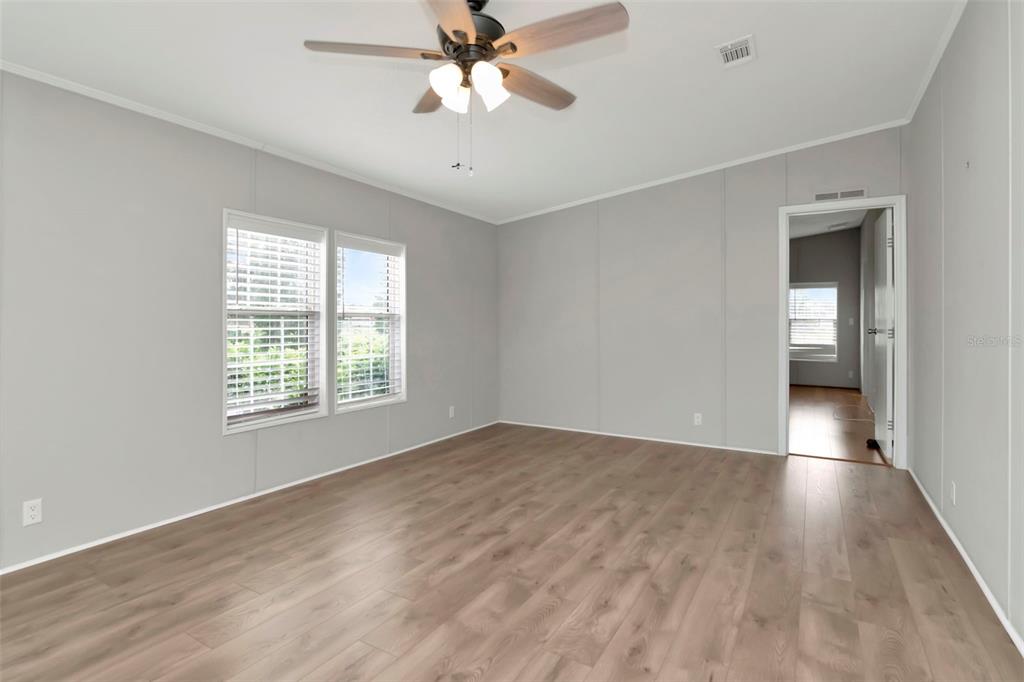 5213 R M D Avenue Plant City, FL 33566 - Photo 11 of 32 a view of an empty room with a window and wooden floor