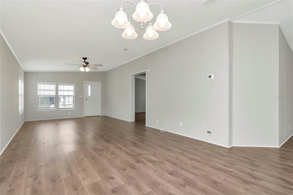 5213 R M D Avenue Plant City, FL 33566 - Photo 14 of 32 a view of an empty room with a window and wooden floor