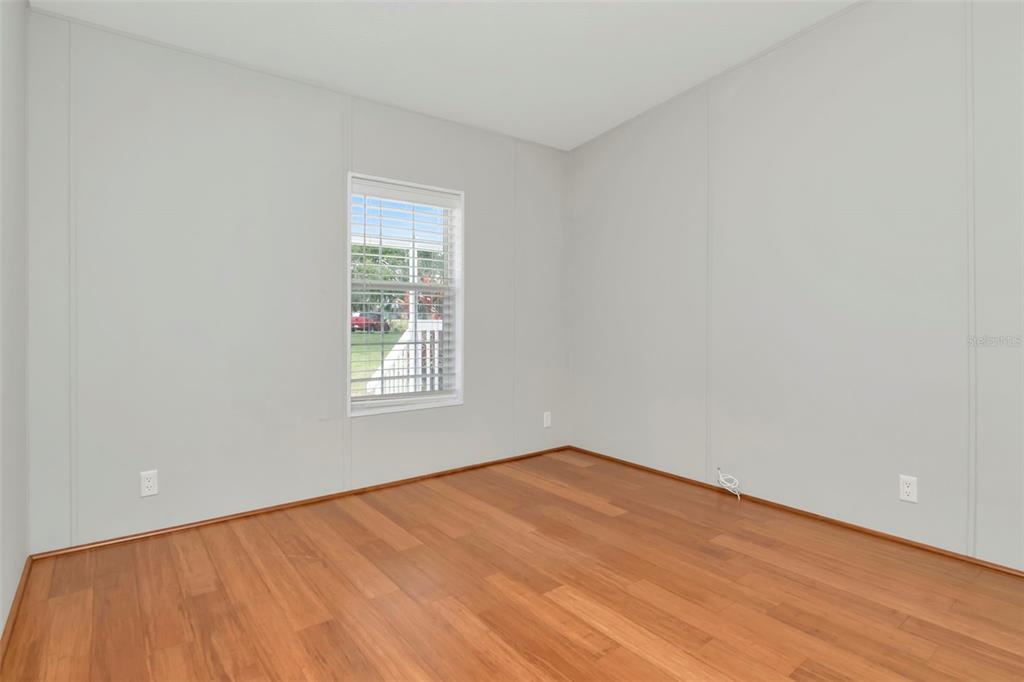 5213 R M D Avenue Plant City, FL 33566 - Photo 23 of 32 a view of an empty room with wooden floor and a window