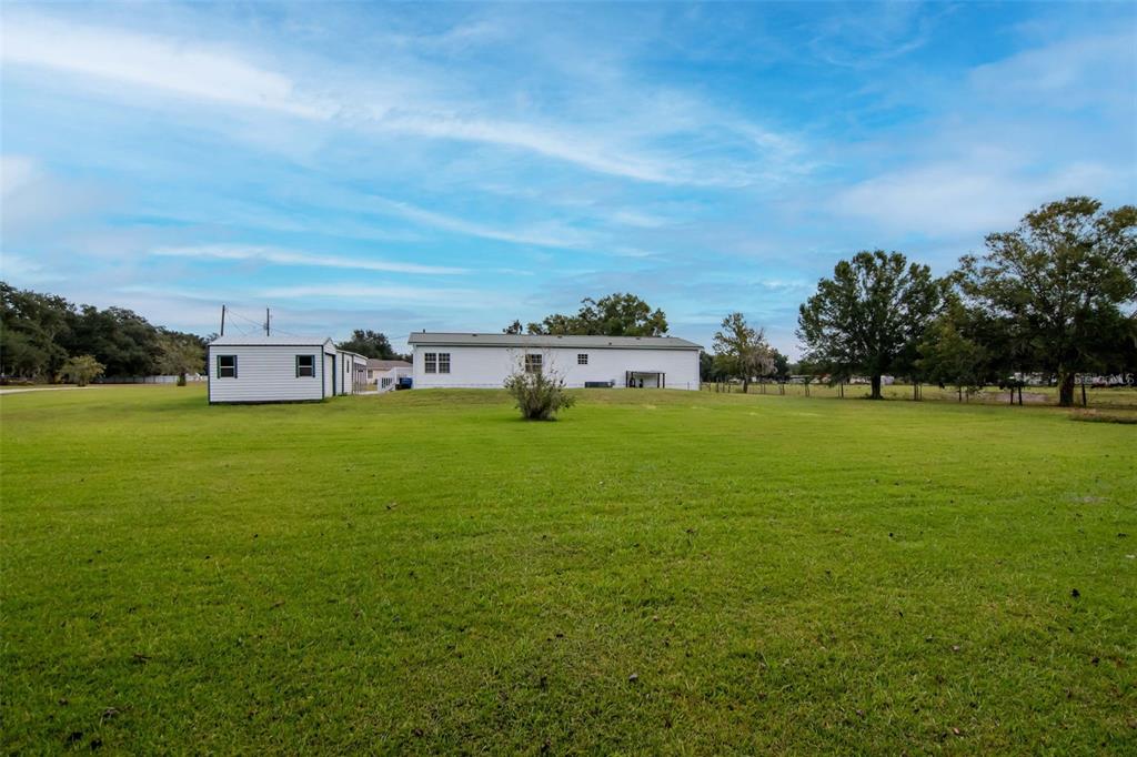 5213 R M D Avenue Plant City, FL 33566 - Photo 28 of 32 a view of a house with a big yard