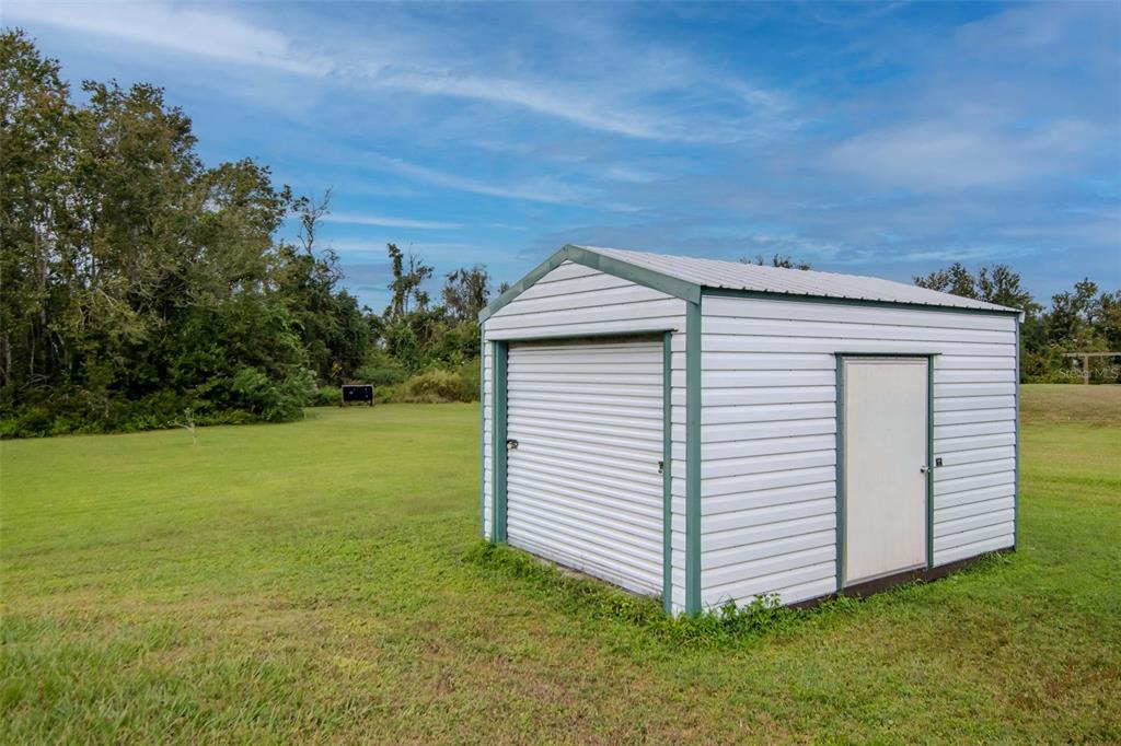 5213 R M D Avenue Plant City, FL 33566 - Photo 31 of 32 a view of a backyard with a garden