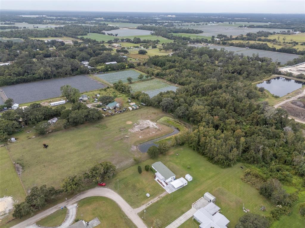 5213 R M D Avenue Plant City, FL 33566 - Photo 4 of 32 an aerial view of a house with a yard