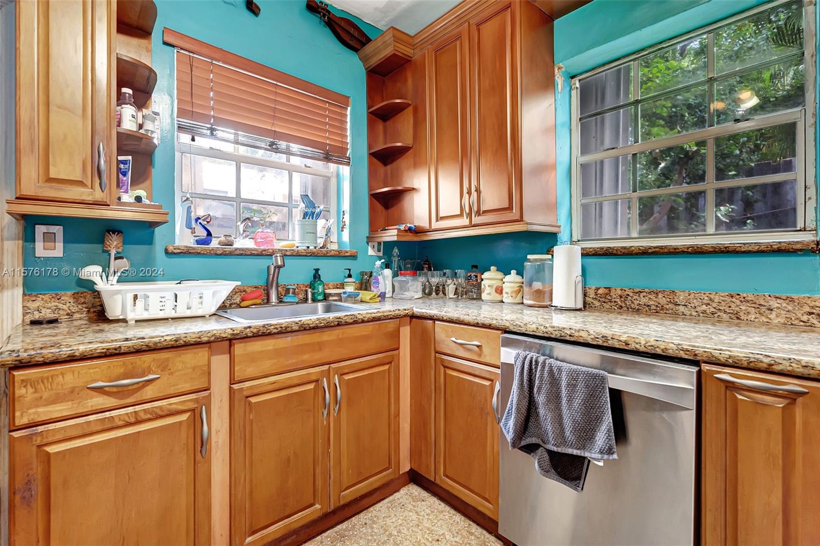 351 Southwest 22nd Road Miami, FL 33129 - Photo 13 of 27 a kitchen with granite countertop a sink and a window