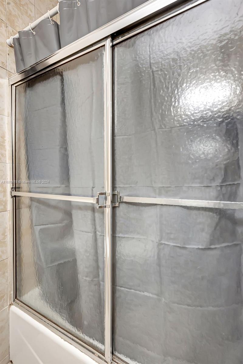351 Southwest 22nd Road Miami, FL 33129 - Photo 18 of 27 a bathroom with a glass shower door