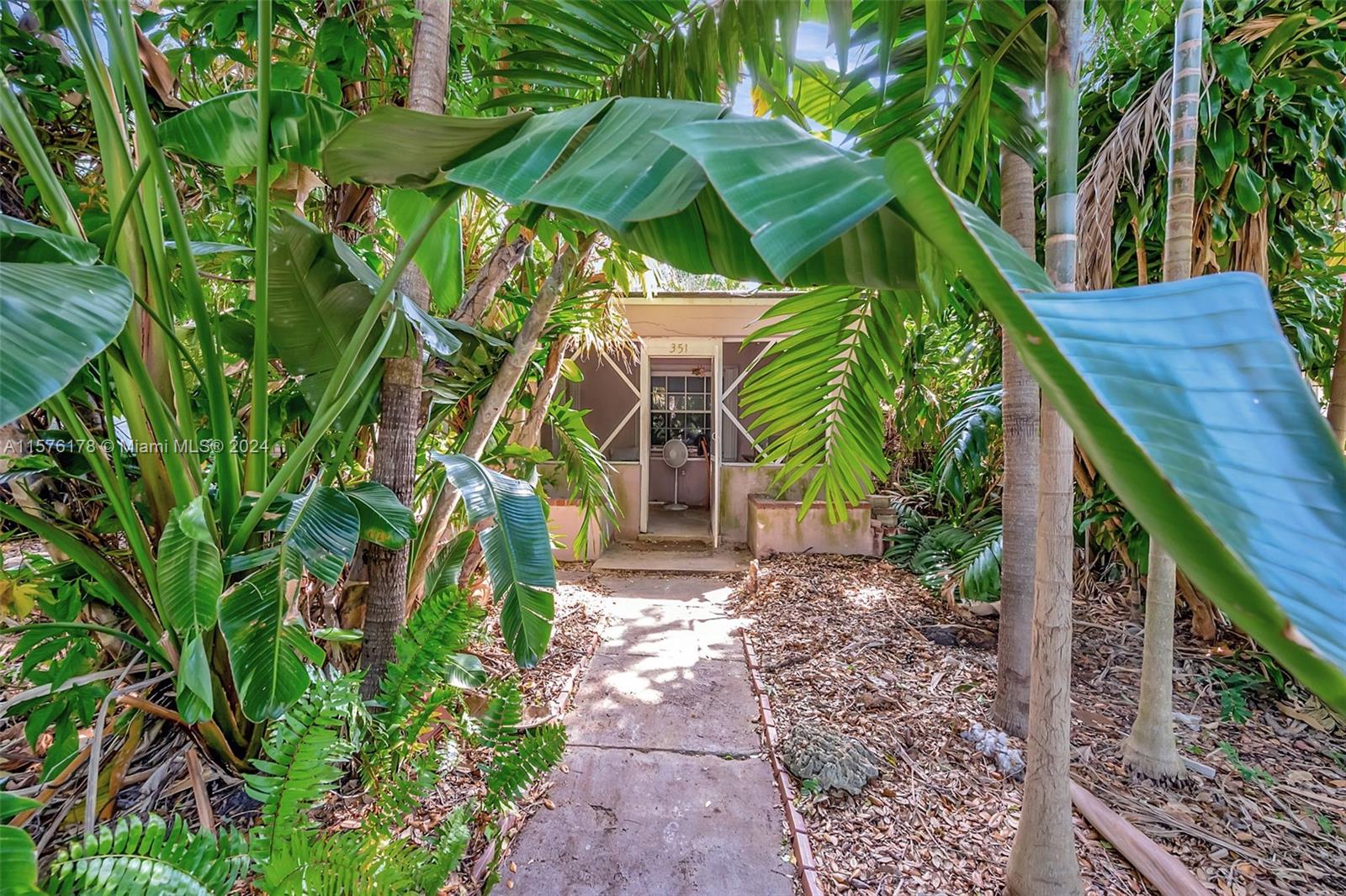 351 Southwest 22nd Road Miami, FL 33129 - Photo 23 of 27 a front view of a house with a yard