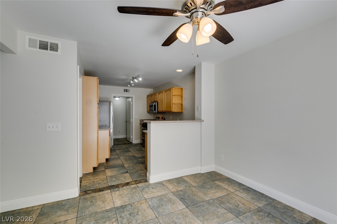 200 Luninborg Street Henderson, NV 89074 - Photo 3 of 40 The kitchen offers ample storage in honey-toned cabinetry and a convenient breakfast bar.