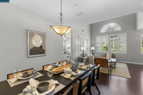 a dining room with furniture window and wooden floor