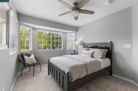 a bedroom with a bed and a potted plant