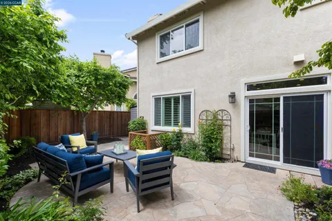 front view of a house with a backyard and sitting area