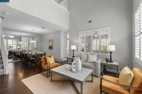 a kitchen with a dining table chairs and refrigerator