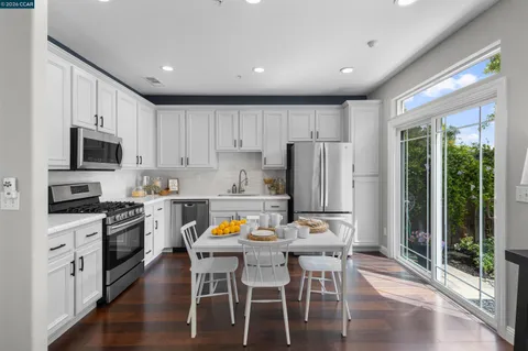 a kitchen with stainless steel appliances a refrigerator stove microwave and cabinets