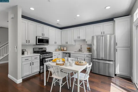 a kitchen with a sink and a potted plant