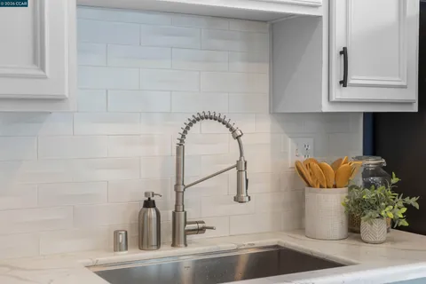 a view of kitchen with sink and breakfast area