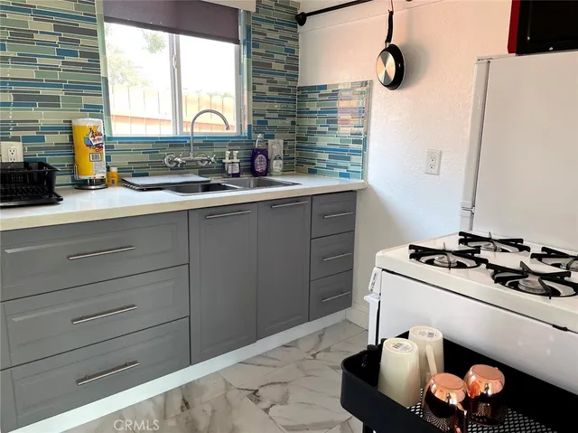 a kitchen with a stove and a sink