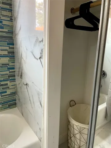 a bathroom with a tub and shower