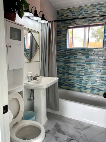 a bathroom with a sink toilet and mirror