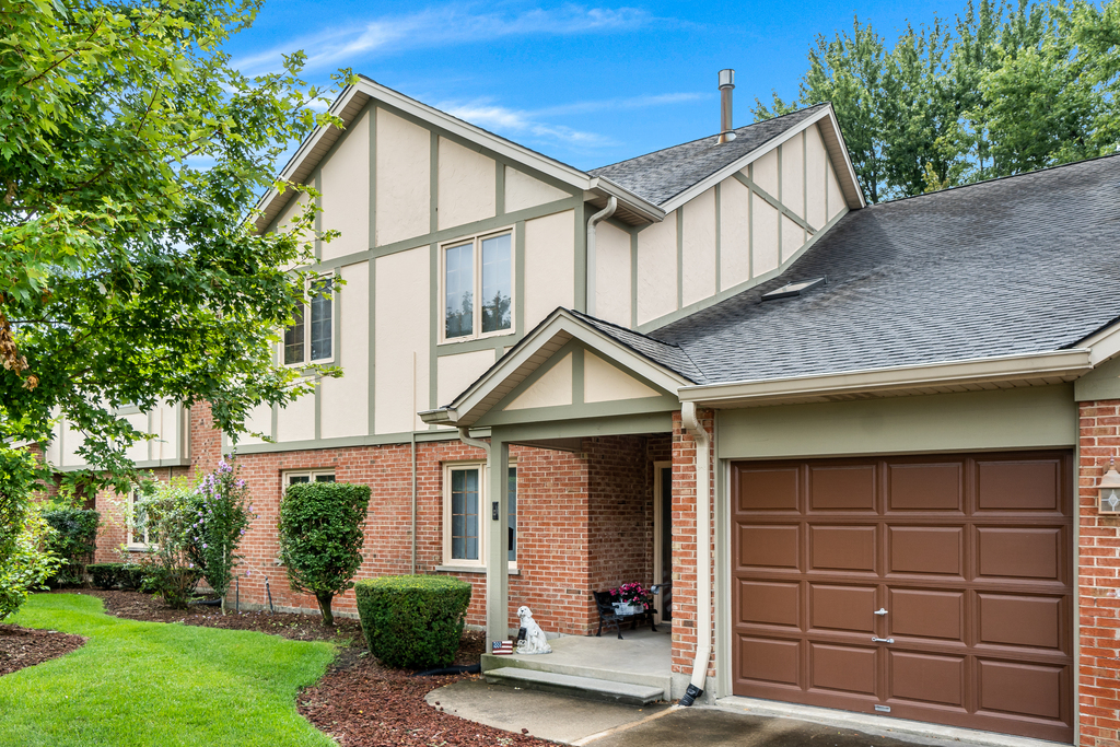 812 Meadow Ridge Lane, Unit 107 New Lenox, IL 60451 - Photo 1 of 15 a front view of a house with a yard