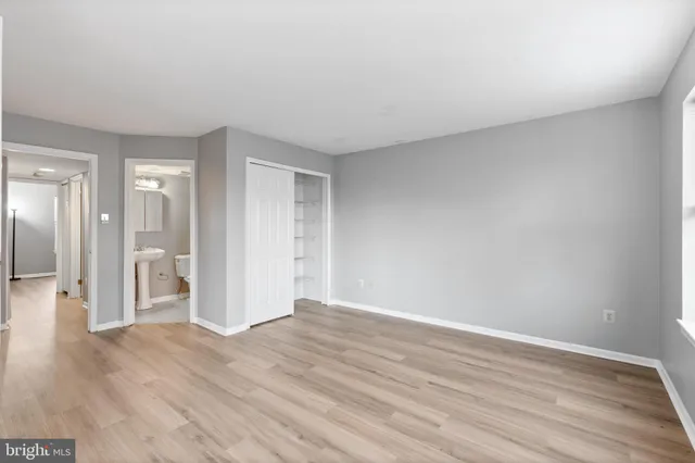 a view of an empty room and wooden floor