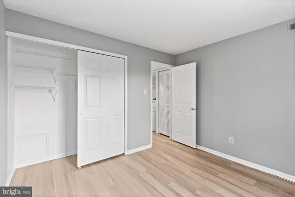 a view of an empty room and wooden floor