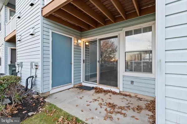 a view of a porch with a wooden bench