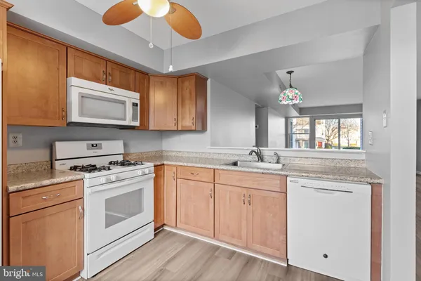 a kitchen with a stove microwave and sink
