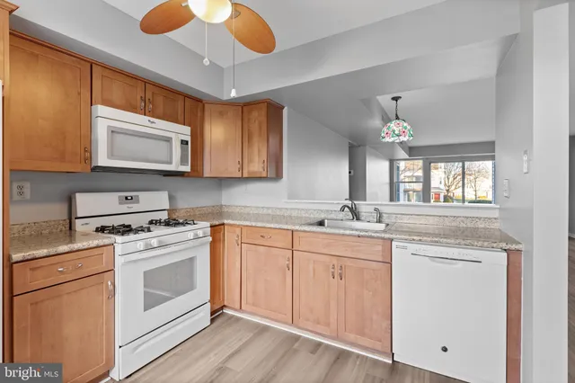 a kitchen with a stove microwave and sink
