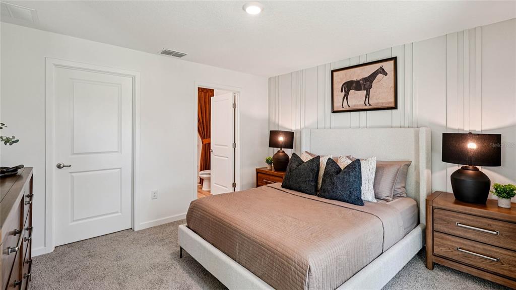 4026 Kona Circle Spring Hill, FL 34608 - Photo 11 of 26 a bedroom with a bed and a walk in closet