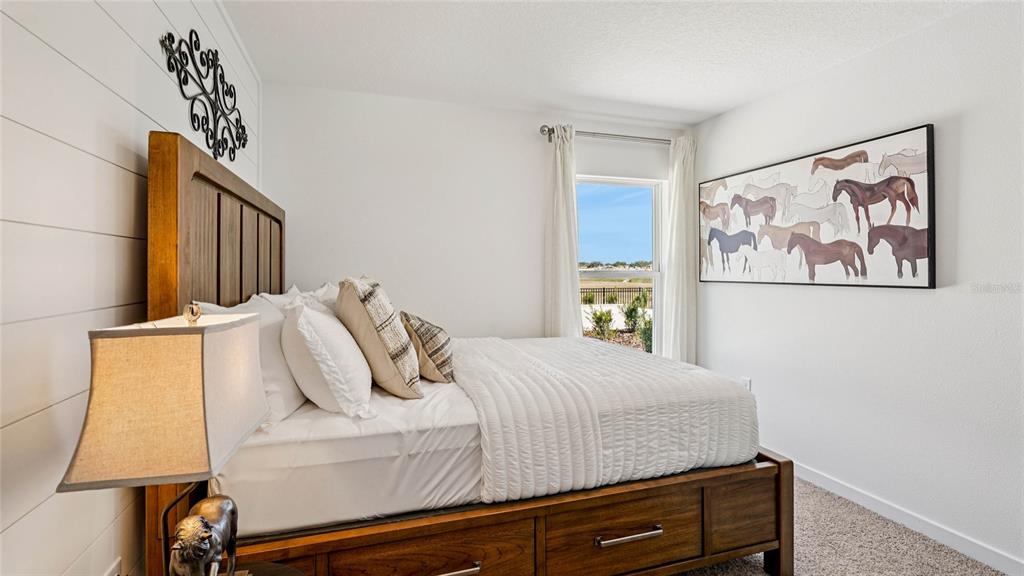 4026 Kona Circle Spring Hill, FL 34608 - Photo 14 of 26 a bedroom with a bed and a painting on the wall
