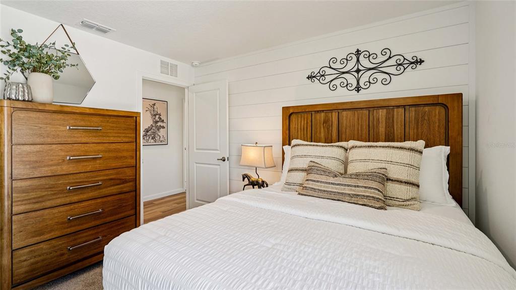 4026 Kona Circle Spring Hill, FL 34608 - Photo 15 of 26 a bedroom with a large bed and a potted plant