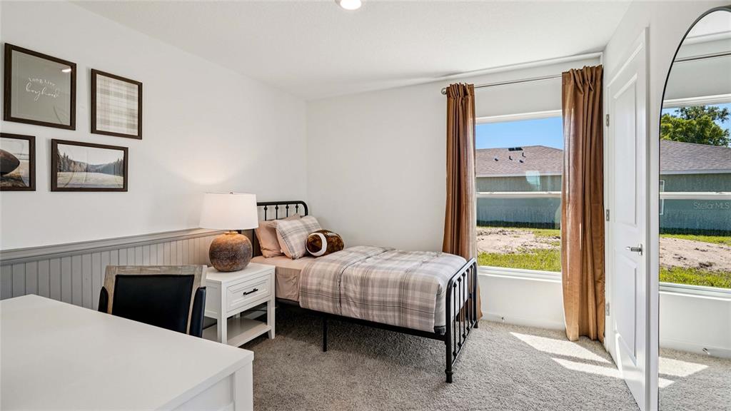 4026 Kona Circle Spring Hill, FL 34608 - Photo 16 of 26 a bedroom with a bed and large window