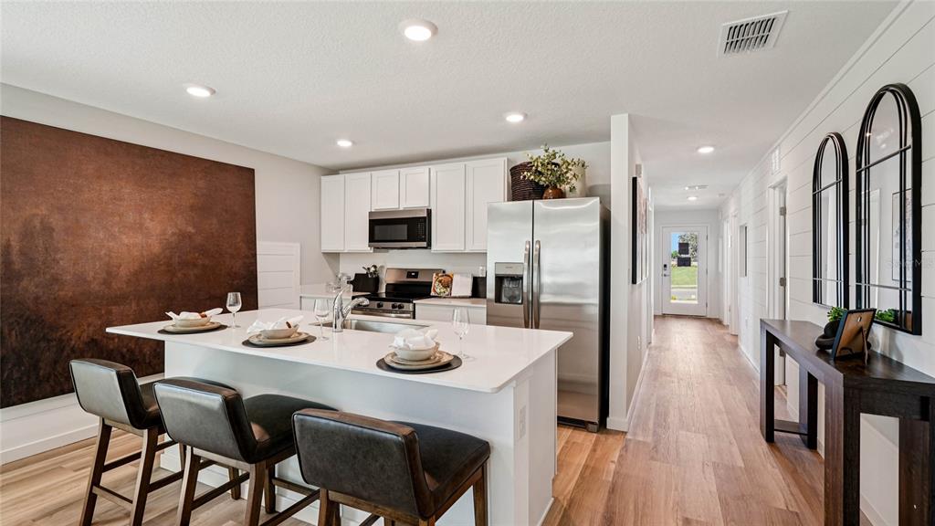 4026 Kona Circle Spring Hill, FL 34608 - Photo 2 of 26 a view of a dining room with furniture and wooden floor