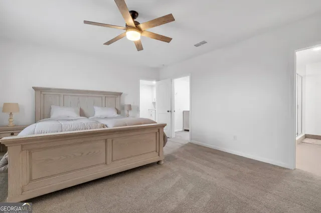 a bedroom with a bed and a ceiling fan