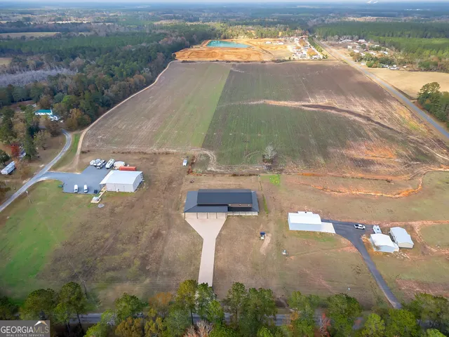 an aerial view of a house with a yard basket ball court and outdoor seating