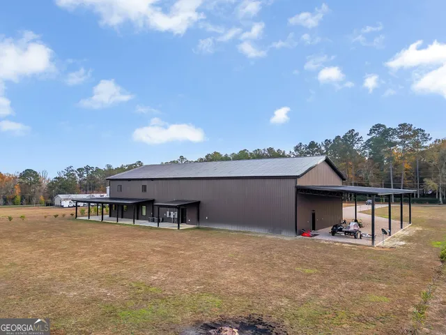 a view of a house with a roof deck and a yard