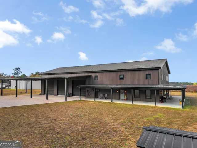 a front view of a house with swimming pool and outdoor seating