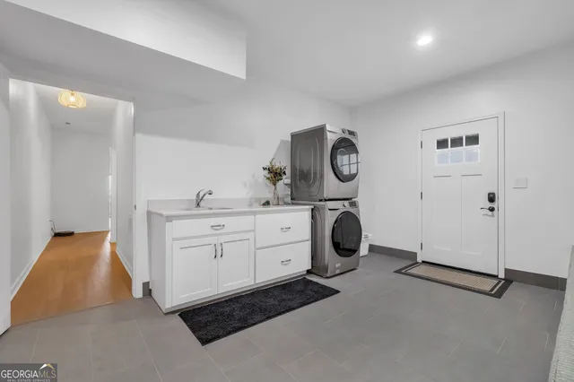 a utility room with sink dryer and washer