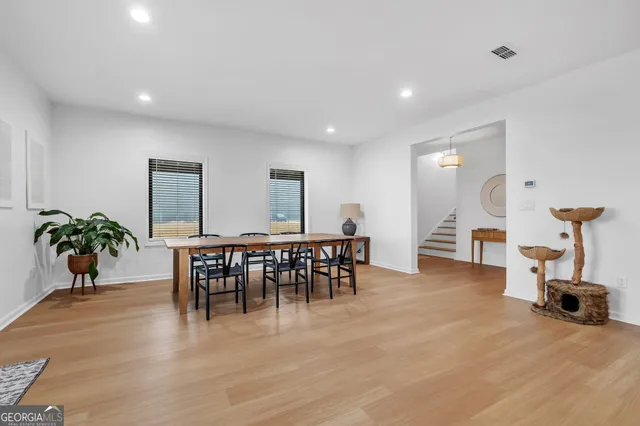 a view of a dining room with furniture and wooden floor