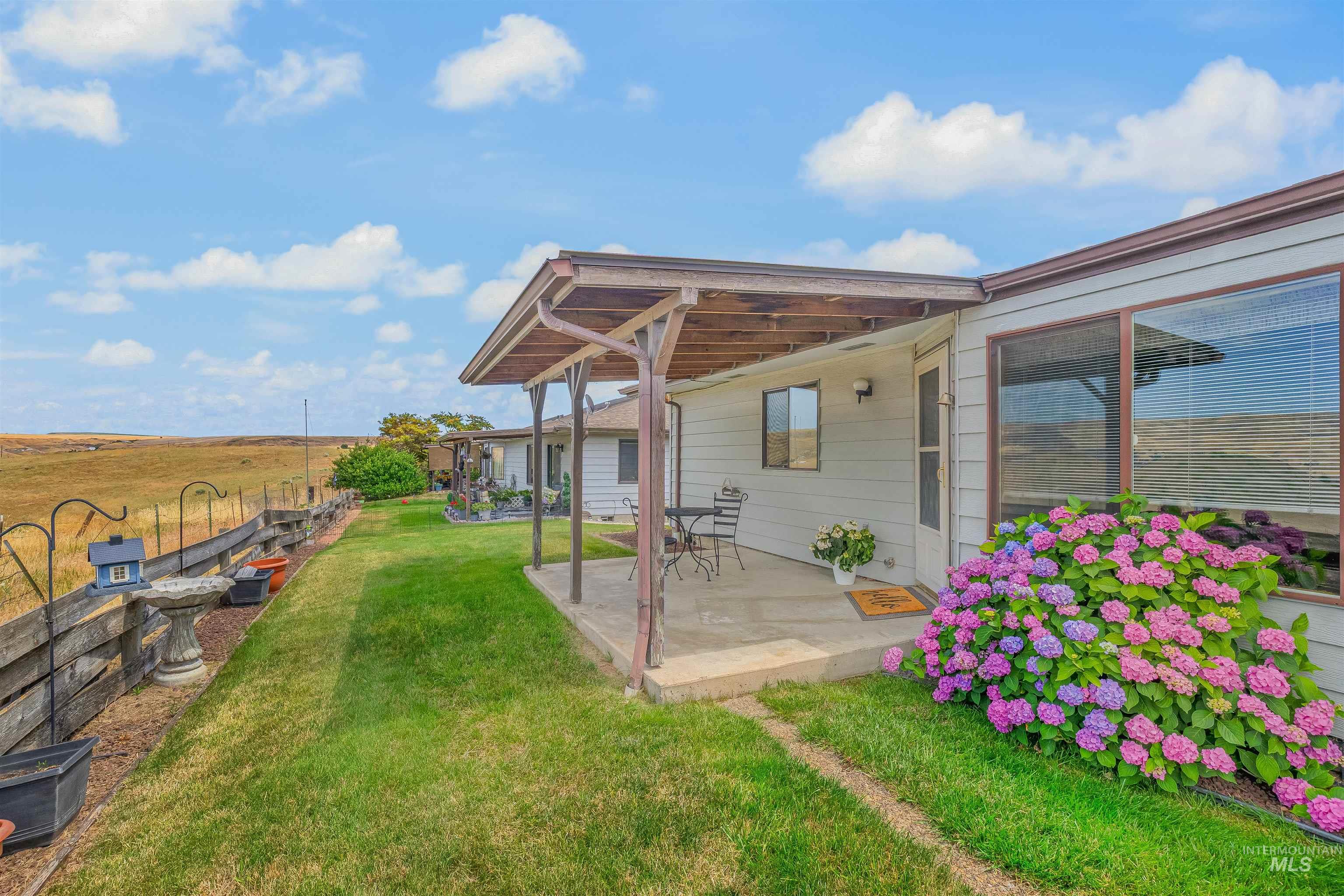 1409 29th Street Lewiston, ID 83501 - Photo 2 of 30 View of grassy yard with a patio and a view of countryside