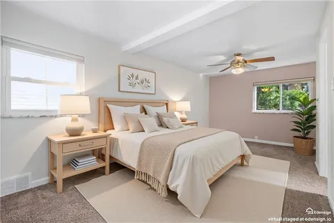a bedroom with a large bed and a chandelier