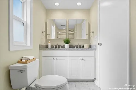 a bathroom with a sink a toilet and mirror