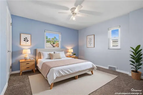 a bedroom with a bed and a potted plant